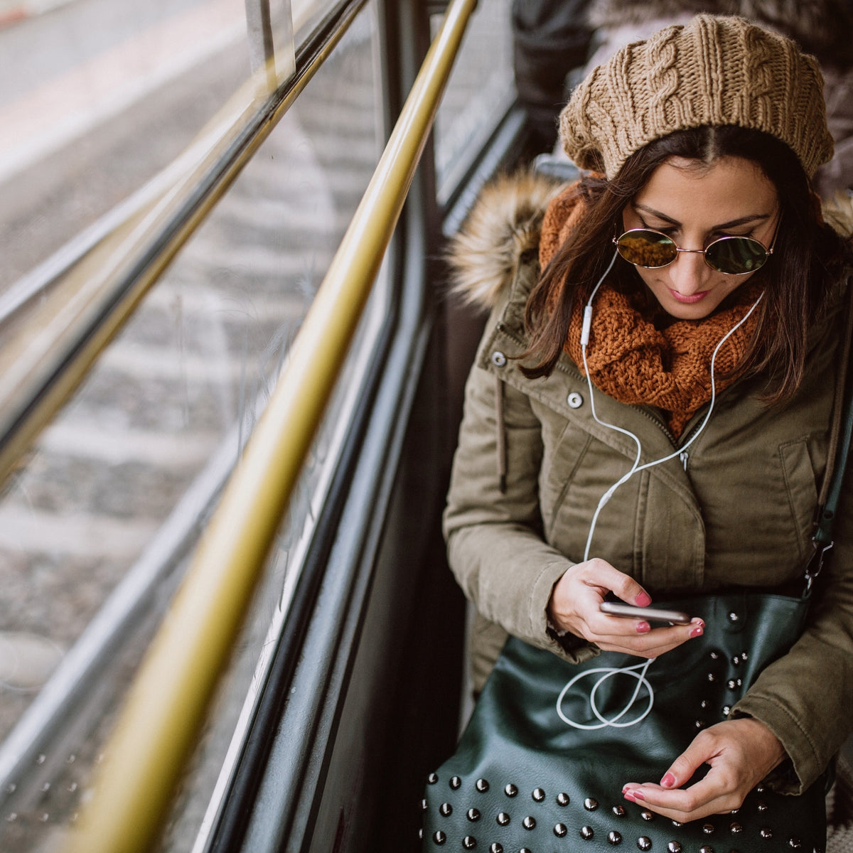 Winter commuter riding light rail in cold-weather clothing